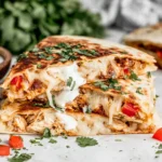 Best Authentic Chicken Quesadilla Recipe with cheesy pull, smoky chicken filling, red peppers, and fresh lime wedges
