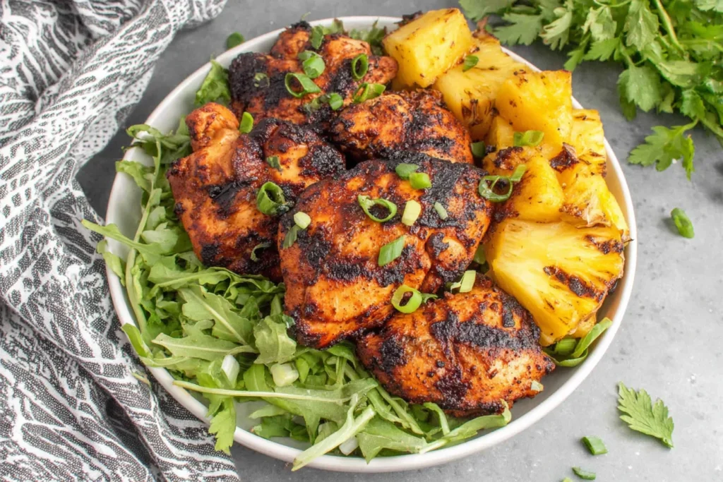 Easy Homemade Grilled Pineapple Chicken served in a bowl with fresh greens and charred pineapple chunks