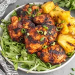 Easy Homemade Grilled Pineapple Chicken served in a bowl with fresh greens and charred pineapple chunks