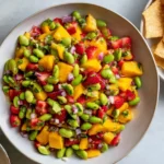 Mango Strawberry Avocado Edamame Salsa served in a bowl with tortilla chips, featuring fresh mango, strawberries, avocado, and edamame