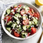 Greek Cucumber Salad tossed with lemon vinaigrette, feta cheese, olives, and fresh vegetables