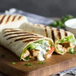 Healthy grilled chicken ranch wraps sliced open with fresh veggies and creamy ranch dressing