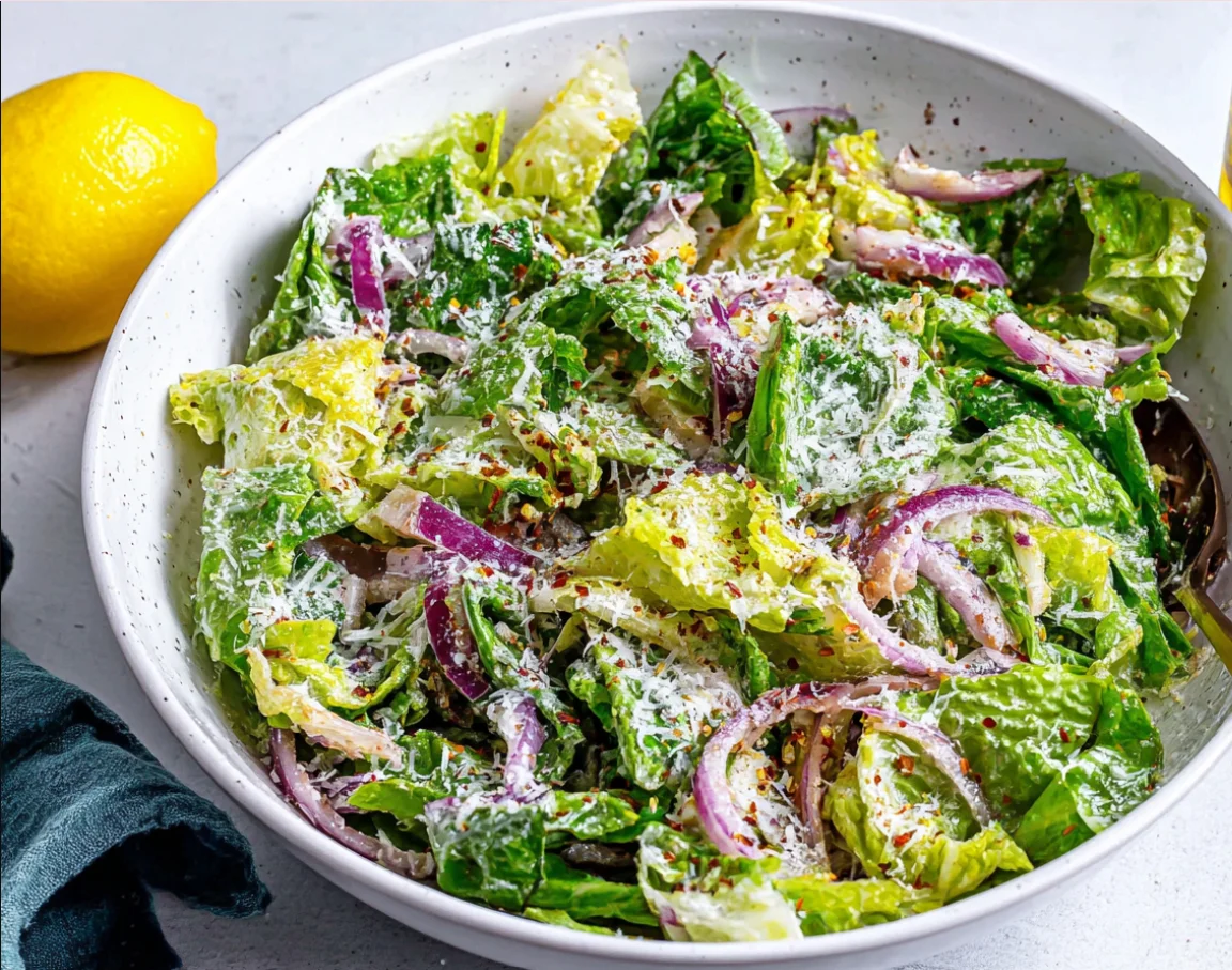 Lemon Parmesan Lettuce Salad Recipe served with fresh lemon, parmesan, romaine lettuce, and sliced red onions