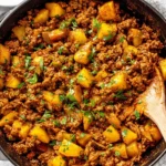 Mexican Picadillo skillet with seasoned ground beef and potatoes topped with fresh cilantro