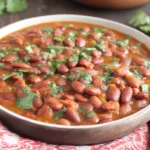 Puerto Rican Style Beans served in a rustic bowl with fresh cilantro garnish