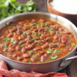 Puerto Rican Style Beans simmered in a skillet with cilantro and rich tomato broth