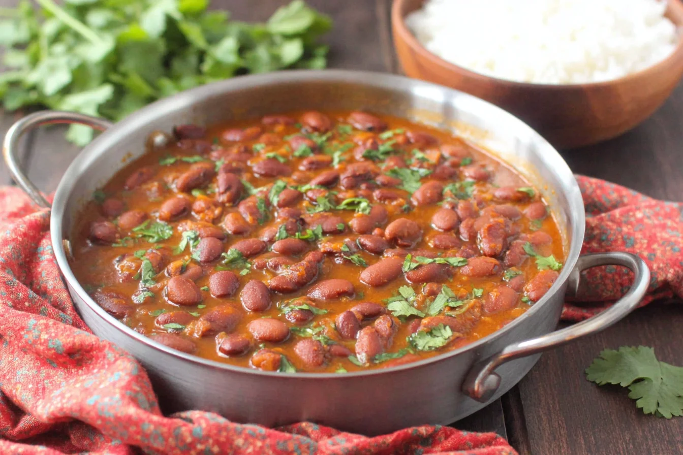 Puerto Rican Style Beans simmered in a skillet with cilantro and rich tomato broth