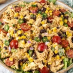 Creamy Southwest Chicken Salad served over lettuce with corn, black beans, and tomatoes