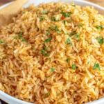 Texas Roadhouse Seasoned Rice in serving bowl with parsley topping