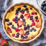 Baked Yogurt topped with mixed berries baked in a round dish for a healthy high-protein breakfast