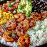 Chipotle Lime Shrimp Bowl with rice, avocado, black beans, corn, fresh salsa, and lime wedges