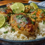 Coconut Lime Chicken and Rice Recipe featuring caramelized chicken thighs, coconut rice, fresh cilantro, and lime wedges