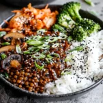 Korean Lentils Vegan Bulgogi Recipe topped with green onions and sesame seeds, served with rice, broccoli, and kimchi