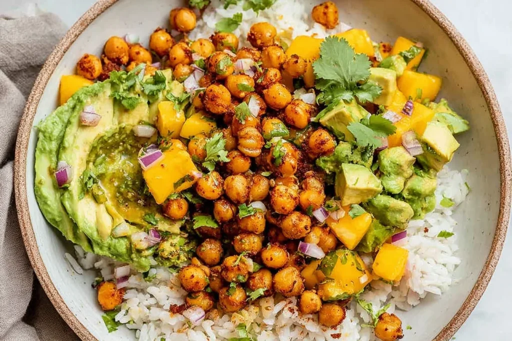 Mango Chickpea Salad Recipe served with crispy roasted chickpeas, avocado, fresh mango, and rice in a healthy vegan bowl