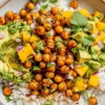Mango Chickpea Salad Recipe served with crispy roasted chickpeas, avocado, fresh mango, and rice in a healthy vegan bowl