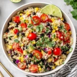 Southwest Quinoa Salad with black beans, cherry tomatoes, corn, cilantro, and lime in a healthy meal-prep bowl