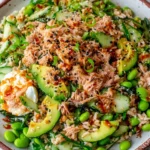Tuna Avocado Crispy Rice Salad topped with avocado, tuna, cucumber, edamame, and sesame seeds