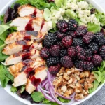 Blackberry Chicken Salad with grilled chicken, fresh blackberries, feta cheese, walnuts, and mixed greens with berry dressing