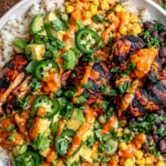 Cilantro Lime Chicken Bowls with grilled chicken, avocado salsa, black beans, corn, rice, and chipotle sauce drizzle