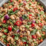 Thai Quinoa Salad with peanut dressing, fresh vegetables, edamame, and cashews in a vibrant healthy bowl