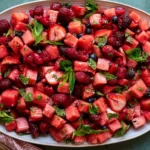 Fresh Watermelon Fruit Salad with berries and lime mint dressing, featuring juicy watermelon cubes, strawberries, raspberries, and blueberries