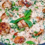 Basil Chicken in Coconut Curry Sauce with creamy coconut milk, golden seared chicken, and fresh basil in a skillet