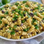 Black Bean & Corn Pasta Salad with creamy dressing, rotini pasta, black beans, corn, and fresh cilantro on a serving platter