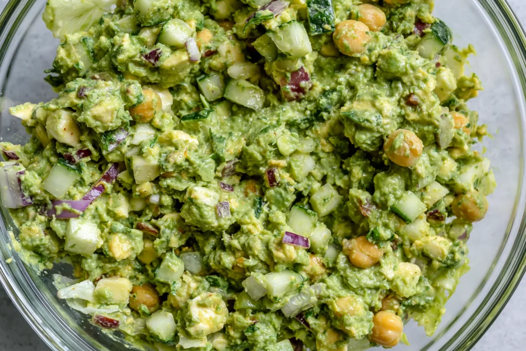 Green Goddess Salad Sandwich filling with chickpeas, avocado, cucumber, and fresh herbs in creamy dressing