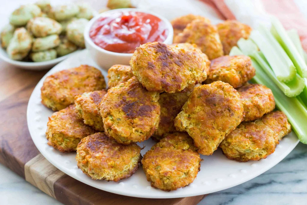 Golden crispy Chickpea Vegetable nuggets served with dipping sauce and fresh celery sticks