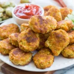 Golden crispy Chickpea Vegetable nuggets served with dipping sauce and fresh celery sticks