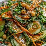 Asian Cucumber and Chickpea Slaw with sesame dressing featuring crisp cucumbers, shredded carrots, chickpeas, and sesame seeds
