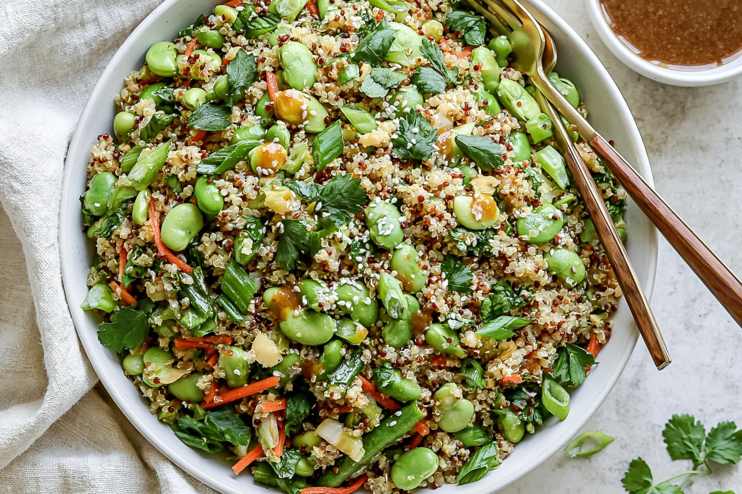 Crunchy Quinoa Edamame Salad with sesame-ginger dressing, fresh vegetables, and toasted almonds in a vibrant healthy bowl