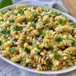 Black Bean & Corn Pasta Salad with creamy lime dressing, rotini pasta, black beans, sweet corn, and fresh cilantro garnish