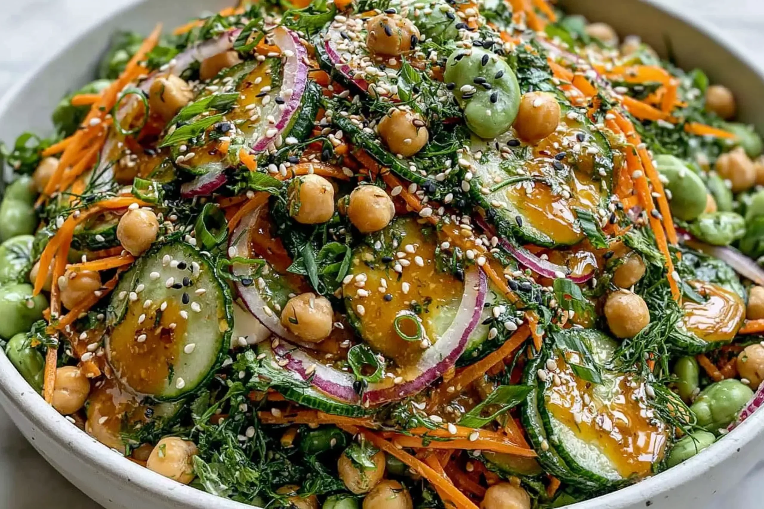 Asian Cucumber and Chickpea Slaw with sesame dressing featuring fresh cucumbers, chickpeas, carrots, and sesame seeds