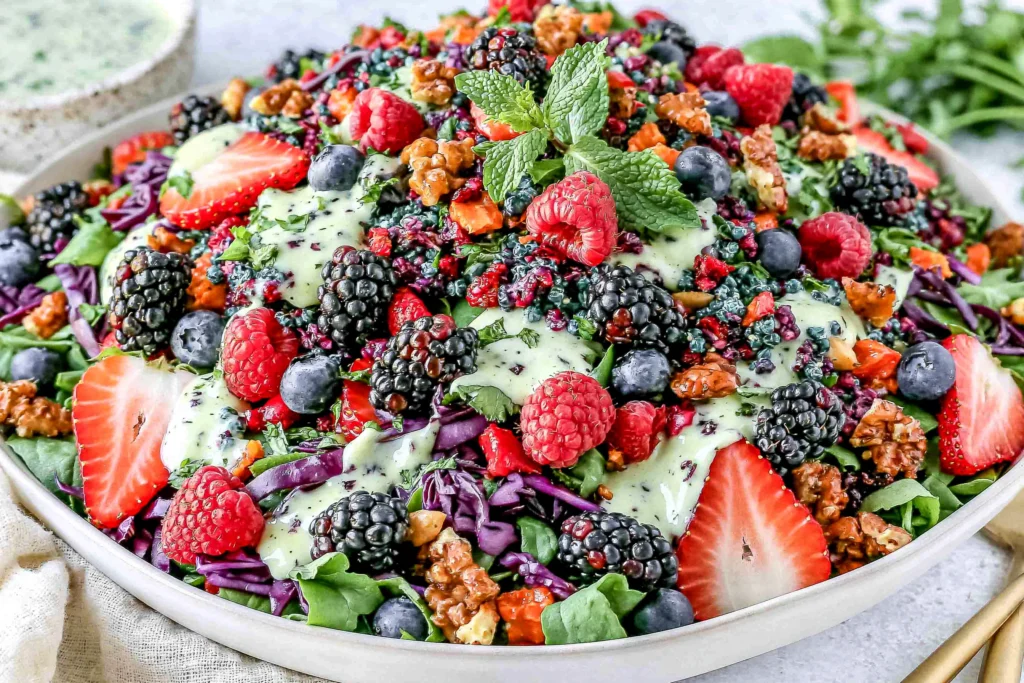 Berry Salad with Creamy Lemon Herb Dressing topped with fresh strawberries, blueberries, blackberries, nuts, and creamy herb dressing