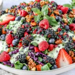 Berry Salad with Creamy Lemon Herb Dressing topped with fresh strawberries, blueberries, blackberries, nuts, and creamy herb dressing