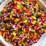 Colorful Black Bean Mango Salad with diced mango, black beans, red onion, bell peppers, and fresh cilantro in a bowl