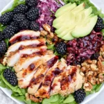Blackberry Chicken Salad with grilled chicken, fresh blackberries, avocado, walnuts, and balsamic dressing on greens