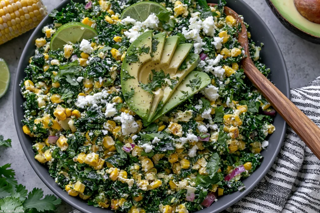 Mexican Street Corn Kale Salad with avocado, cotija cheese, and grilled corn in a bowl