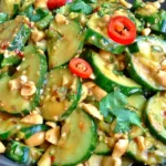 Spicy Peanut Cucumber Salad with sliced cucumbers, crushed peanuts, fresh cilantro, and spicy creamy peanut dressing
