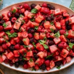 Watermelon Fruit Salad with berries and lime mint dressing, featuring fresh watermelon, strawberries, raspberries, and cherries