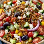 Greek Lentil Salad served with feta cheese, cucumber, cherry tomatoes, red onion, olives, and a zesty homemade vinaigrette.