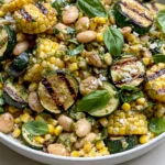 Grilled Zucchini and Corn White Bean Salad with charred corn rounds, grilled zucchini slices, creamy cannellini beans, and fresh basil