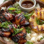 Hawaiian Chicken BBQ bowl with grilled pineapple, glazed chicken, rice, and dipping sauce topped with green onions