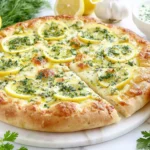 Homemade Lemon Pizza with mozzarella, fresh herbs, and lemon slices on a crispy golden crust