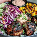 Jerk Chicken & Mango Slaw Bowls with grilled chicken, cabbage slaw, rice, and creamy honey lime sauce