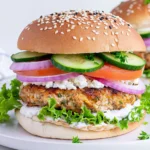 Greek Feta Turkey Burgers with tzatziki, cucumber, tomato, red onion, and feta on a sesame bun