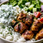 Mediterranean Lemon-Dill Chicken Bowls Recipe with grilled lemon herb chicken, basmati rice, fresh vegetables, feta, and creamy homemade tzatziki