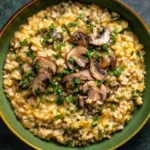 Creamy Miso Butter Mushroom Risotto topped with sautéed mushrooms and fresh parsley in a rustic bowl