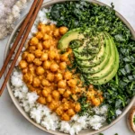 Peanut Chickpea & Veggie Bowls with creamy peanut sauce, rice, kale, and avocado slices in a healthy plant-based meal